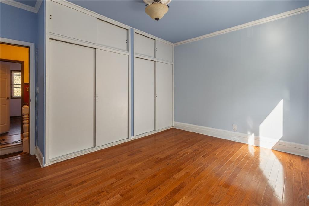 231 Monitor Street Brooklyn, NY 11222 - Photo 31 of 37 a view of an empty room with wooden floor and a window