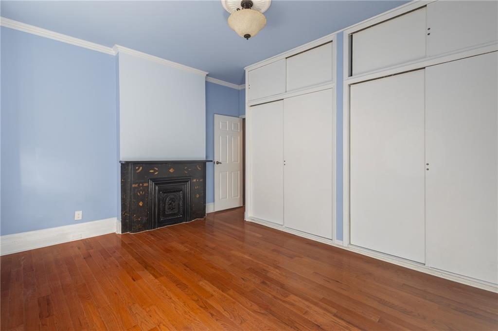 231 Monitor Street Brooklyn, NY 11222 - Photo 32 of 37 a view of an empty room with cabinet and wooden floor