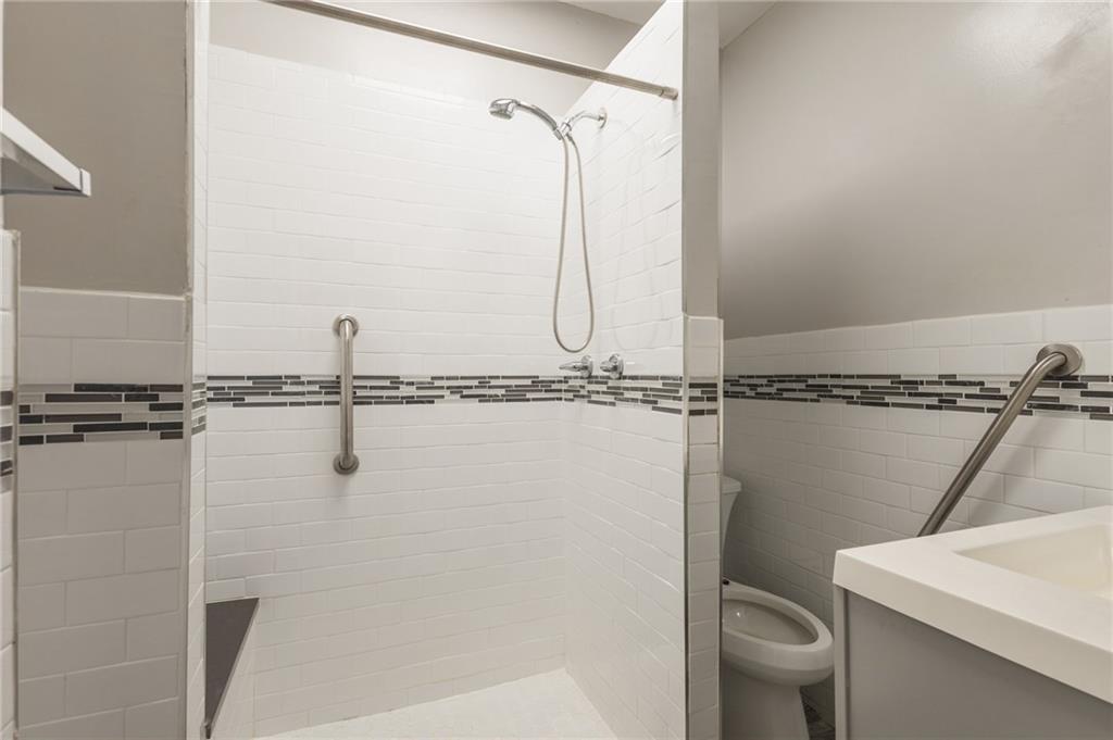231 Monitor Street Brooklyn, NY 11222 - Photo 7 of 37 a bathroom with a shower a toilet and a sink