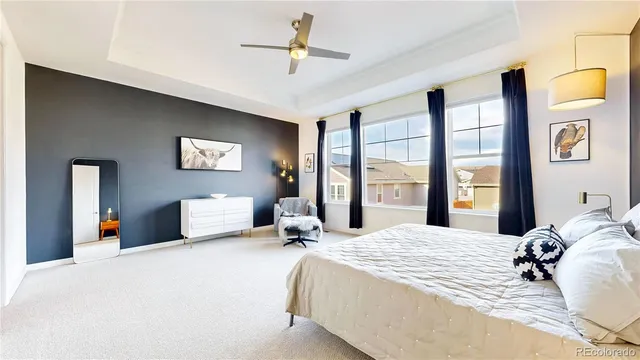 a bedroom with a large bed and a chandelier