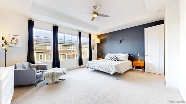 a spacious bedroom with a bed and a couch