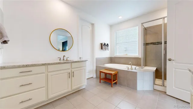 a spacious bathroom with a double vanity sink a mirror and a