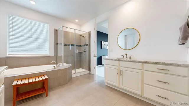 a spacious bathroom with a double vanity sink a mirror and a bathtub