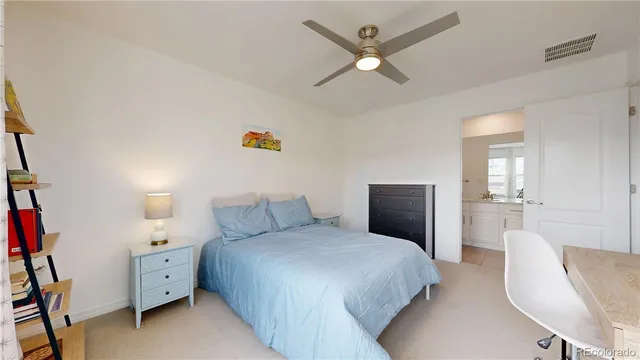 a spacious bedroom with a bed and a chandelier