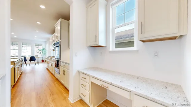 a hallway with a sink and a wooden floor