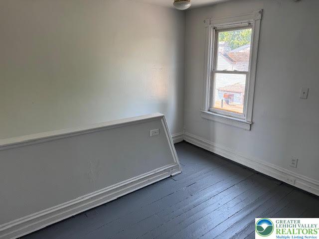 208 Ridge Avenue Allentown, PA 18102 - Photo 14 of 17 an empty room with wooden floor and windows