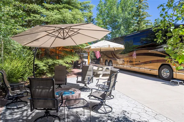 a view of a patio with a table and chairs under an umbrella