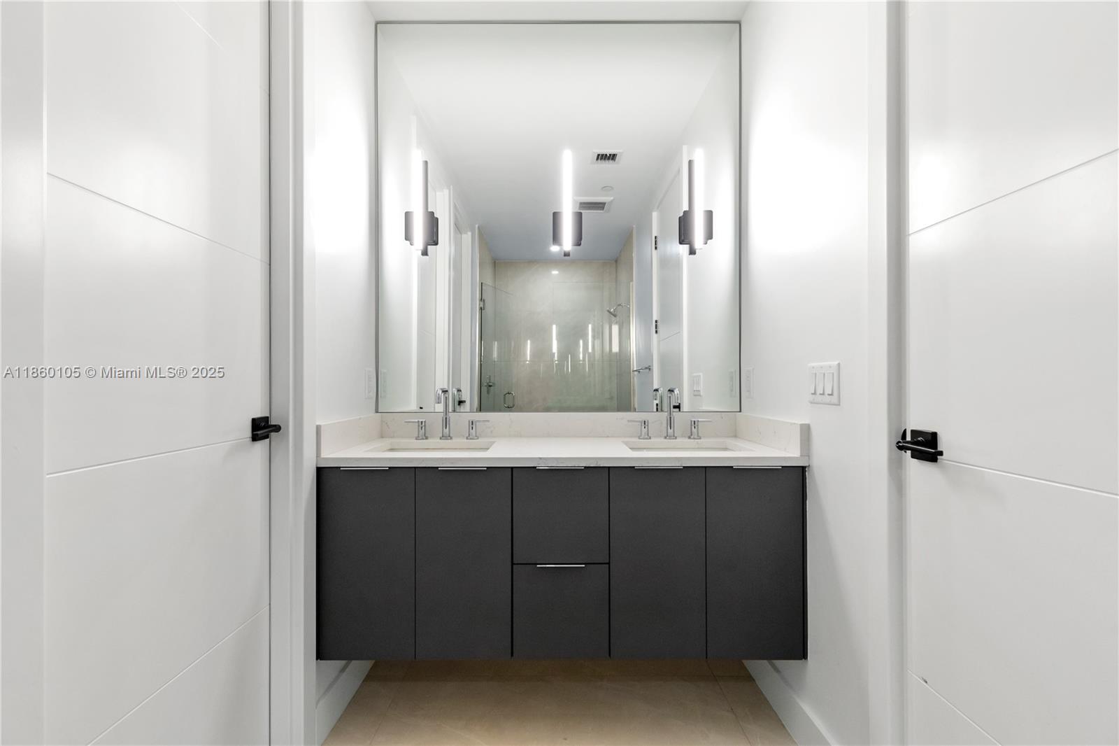 436 Southeast 12th Court Fort Lauderdale, FL 33316 - Photo 14 of 34 a bathroom with a double vanity sink and mirror