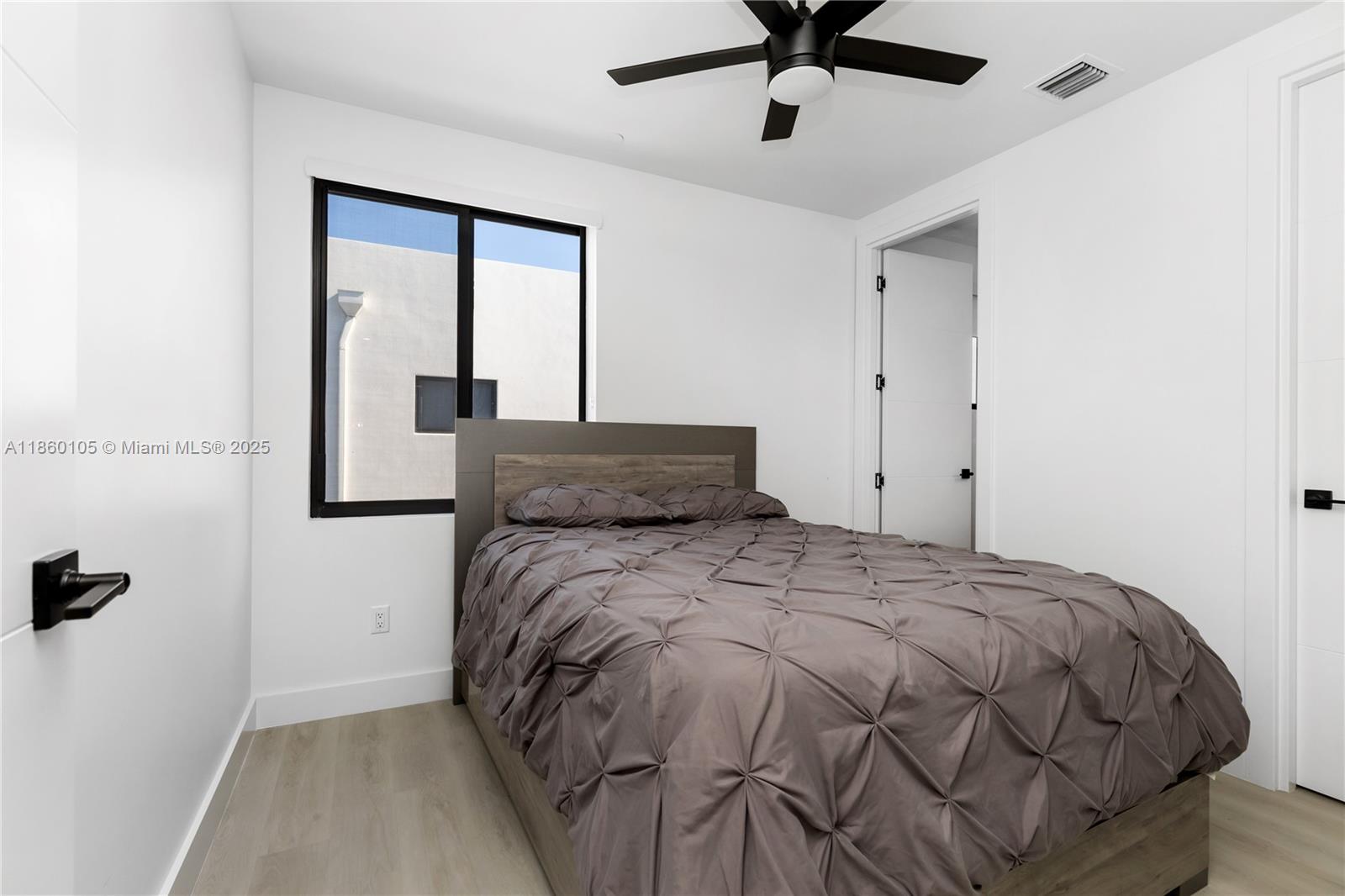 436 Southeast 12th Court Fort Lauderdale, FL 33316 - Photo 15 of 34 a bed sitting in a bedroom next to a window