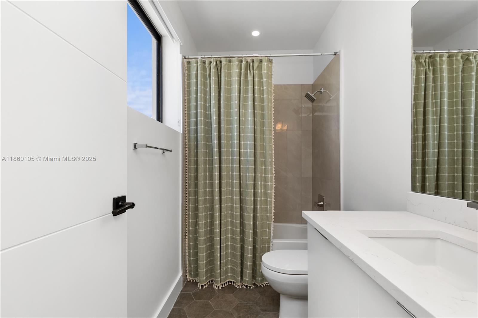 436 Southeast 12th Court Fort Lauderdale, FL 33316 - Photo 17 of 34 a bathroom with a shower and a toilet