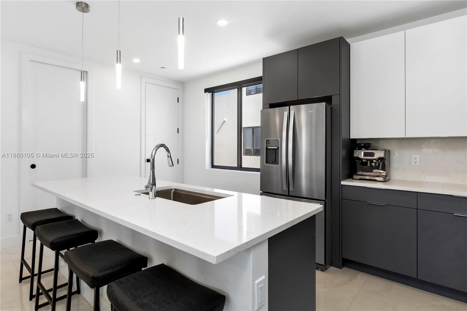 436 Southeast 12th Court Fort Lauderdale, FL 33316 - Photo 8 of 34 a kitchen with sink cabinets and refrigerator