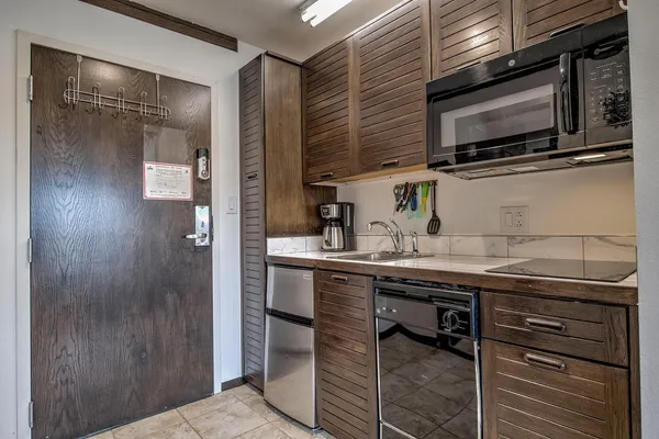 a kitchen with stainless steel appliances a sink and cabinets