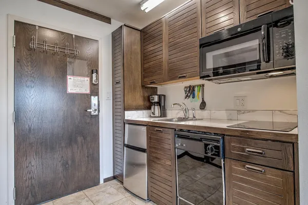 a kitchen with stainless steel appliances a sink and cabinets