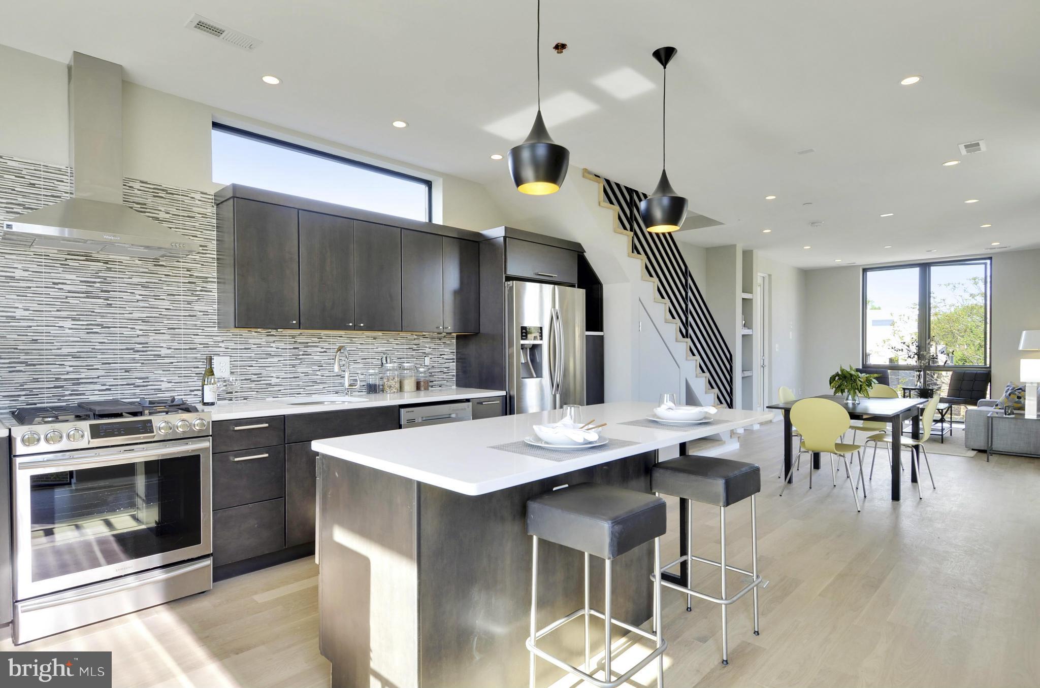 a kitchen with a table chairs sink and stove