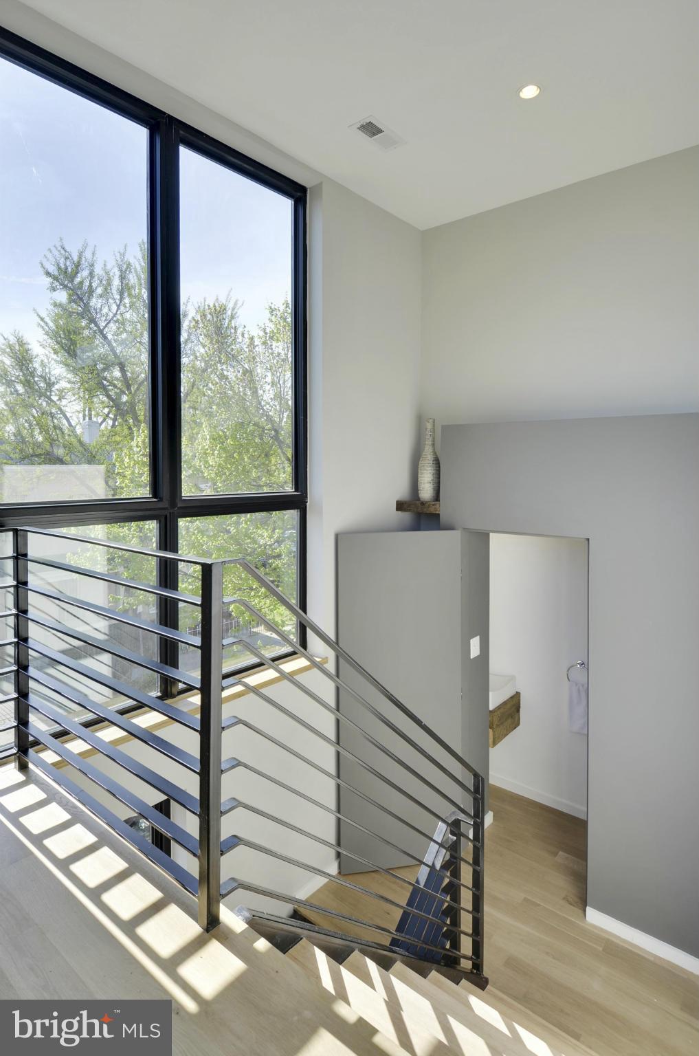 706 16th Street Northeast, Unit 2 Washington, DC 20002 - Photo 2 of 26 a view of a balcony with wooden floor and iron stairs