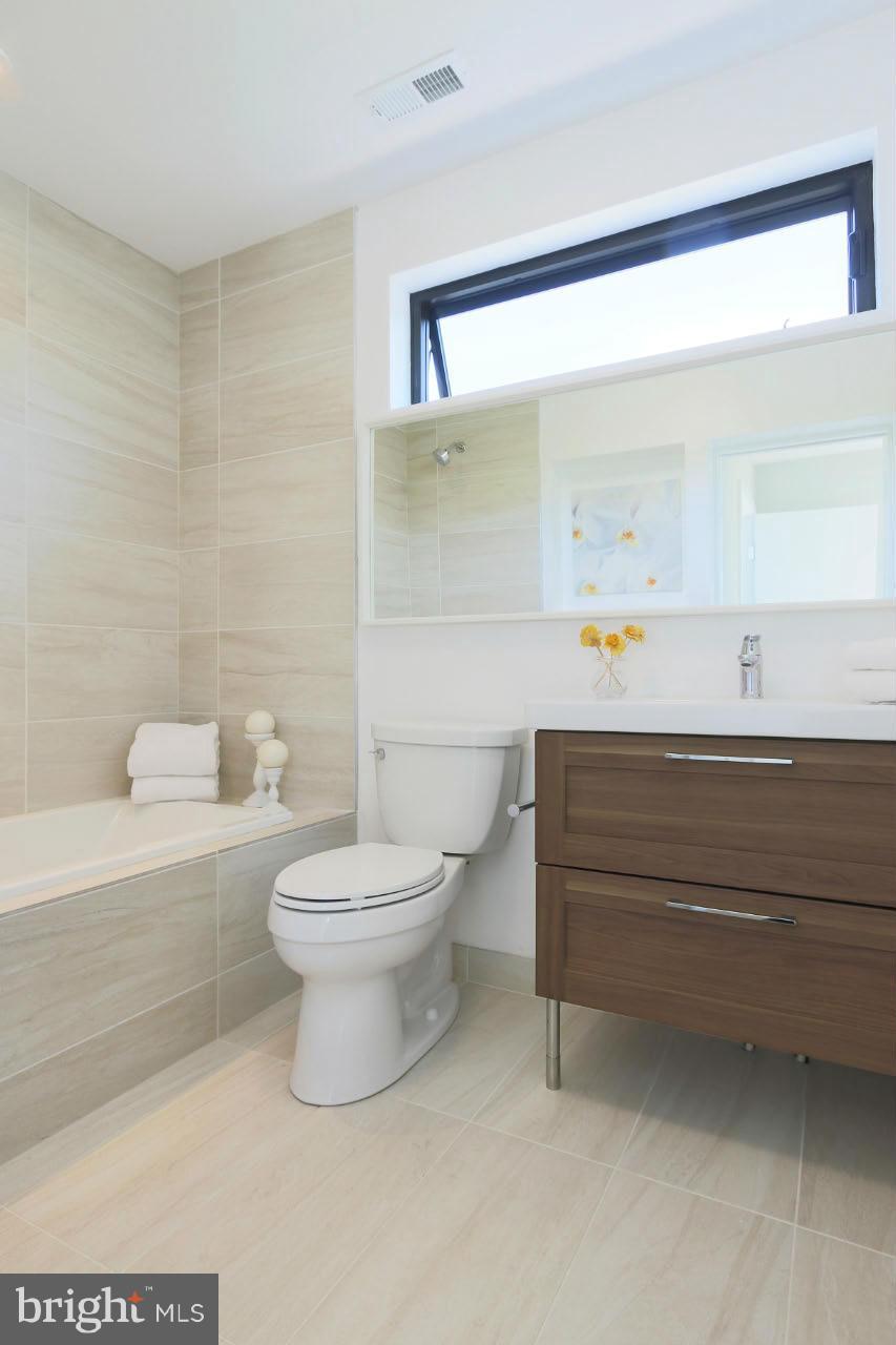 706 16th Street Northeast, Unit 2 Washington, DC 20002 - Photo 11 of 26 a bathroom with a toilet a sink and bathtub