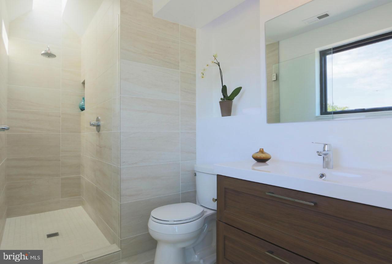 706 16th Street Northeast, Unit 2 Washington, DC 20002 - Photo 15 of 26 a bathroom with a sink and a mirror