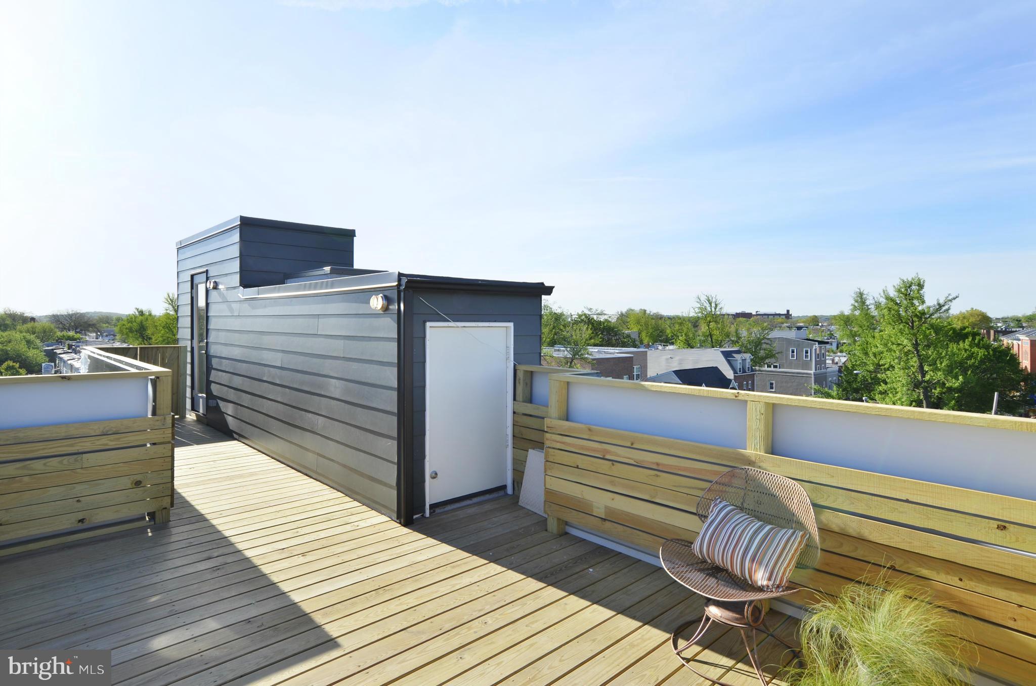 706 16th Street Northeast, Unit 2 Washington, DC 20002 - Photo 22 of 26 a view of a balcony with two chairs and a potted plant