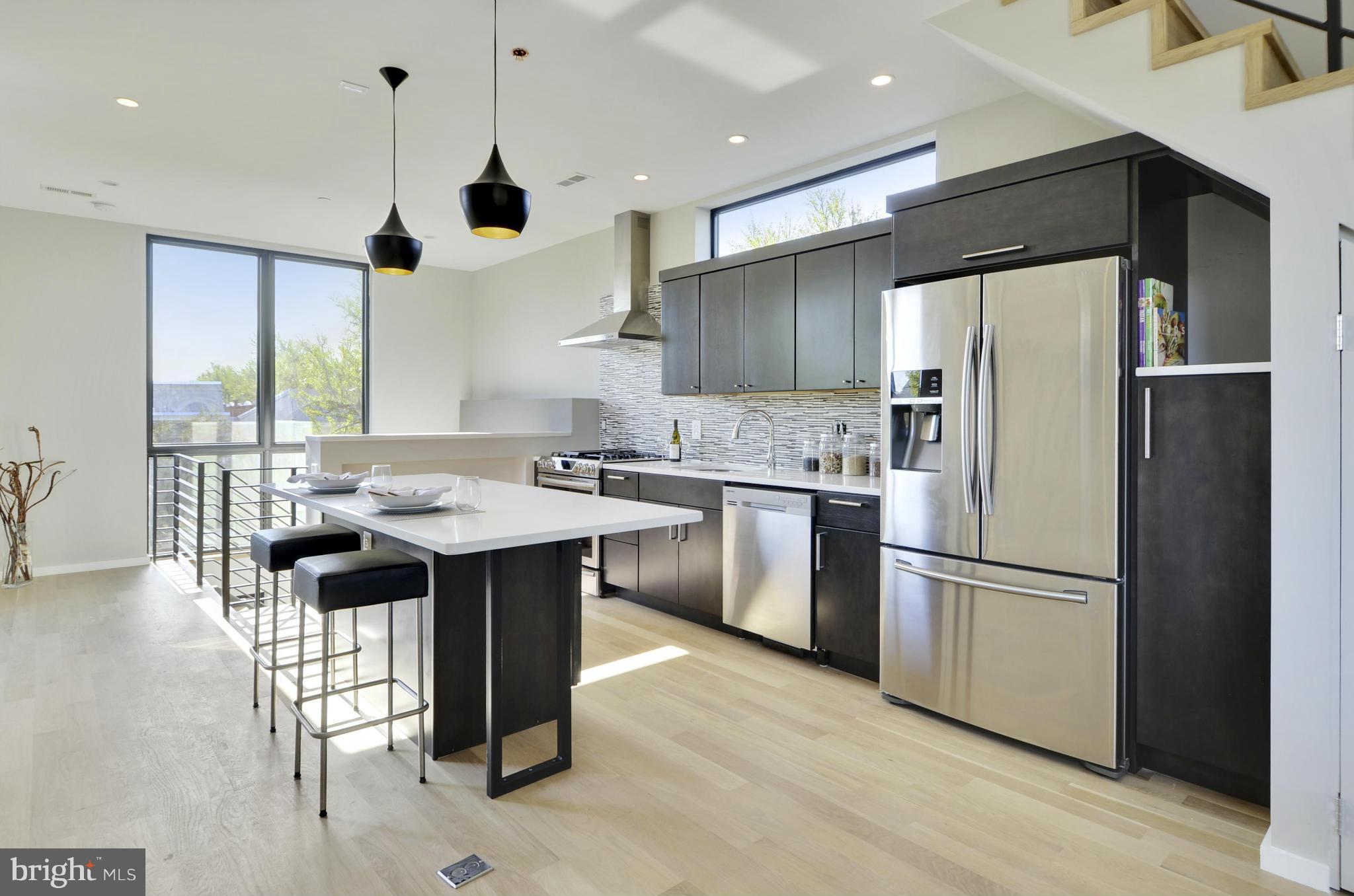 706 16th Street Northeast, Unit 2 Washington, DC 20002 - Photo 4 of 26 a kitchen with refrigerator cabinets and wooden floor