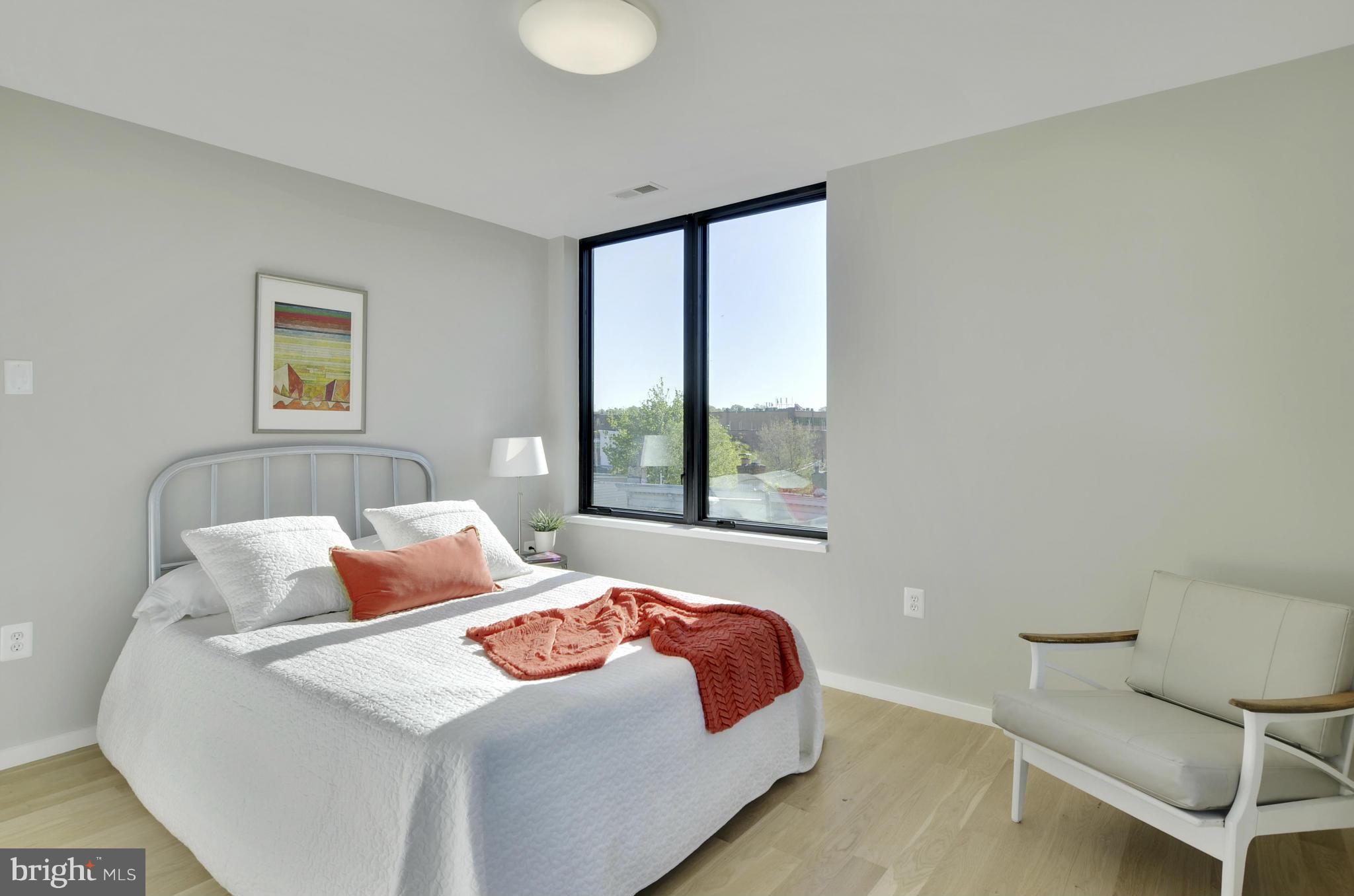 706 16th Street Northeast, Unit 2 Washington, DC 20002 - Photo 9 of 26 a bedroom with a bed and a window