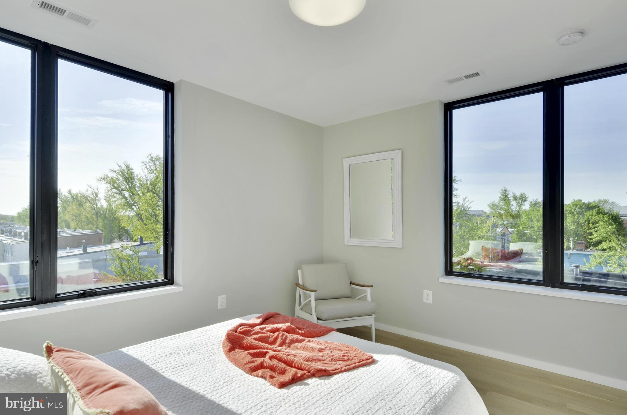 706 16th Street Northeast, Unit 2 Washington, DC 20002 - Photo 10 of 26 a bedroom with a bed and a window