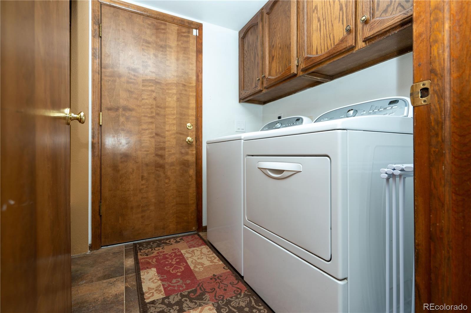 8583 Redstone Street Highlands Ranch, CO 80126 - Photo 17 of 17 a utility room with dryer and washer
