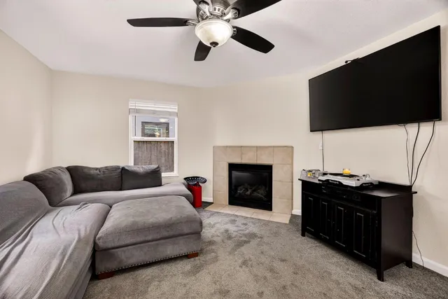 a living room with a flat screen tv and a fireplace