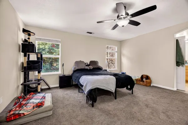 a spacious bedroom with a bed and a window