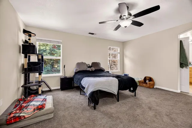 a spacious bedroom with a bed and a window