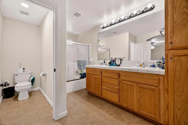 a bathroom with a double vanity sink and a mirror