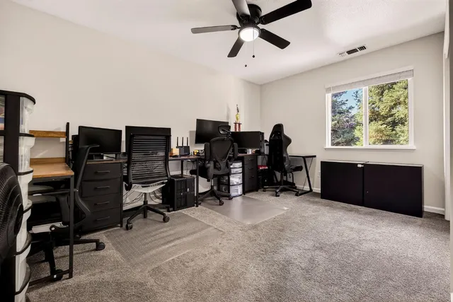 a view of a workspace with furniture and a window