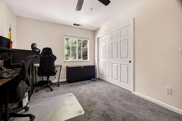 a view of a workspace with furniture and a window