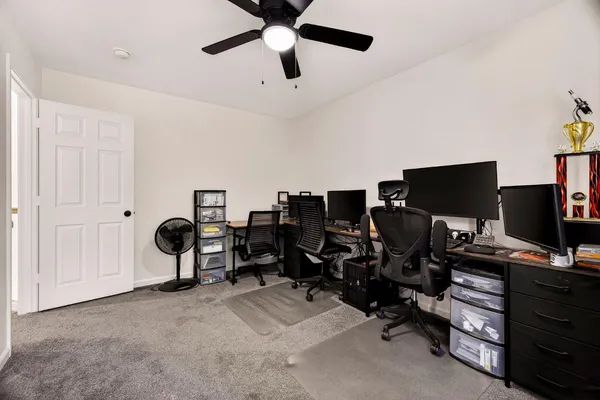 a kitchen with white cabinets and sink