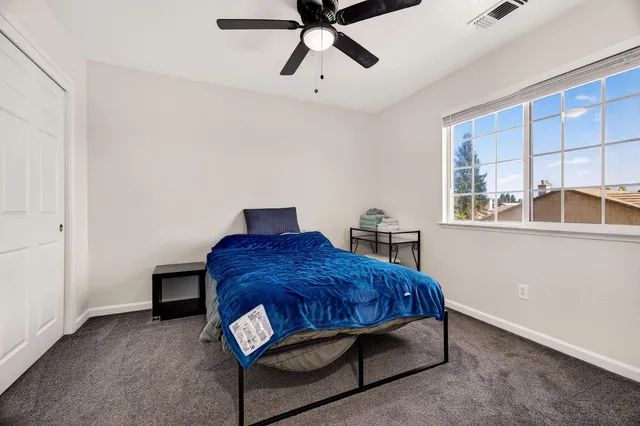 a bedroom with a bed and window