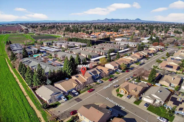 an aerial view of residential houses with outdoor space