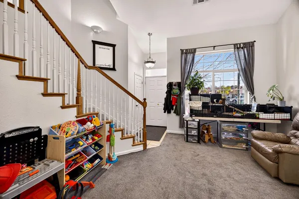 a living room with furniture and a chandelier