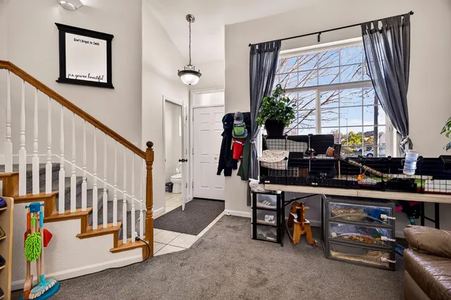 a living room with furniture a chandelier and a couch