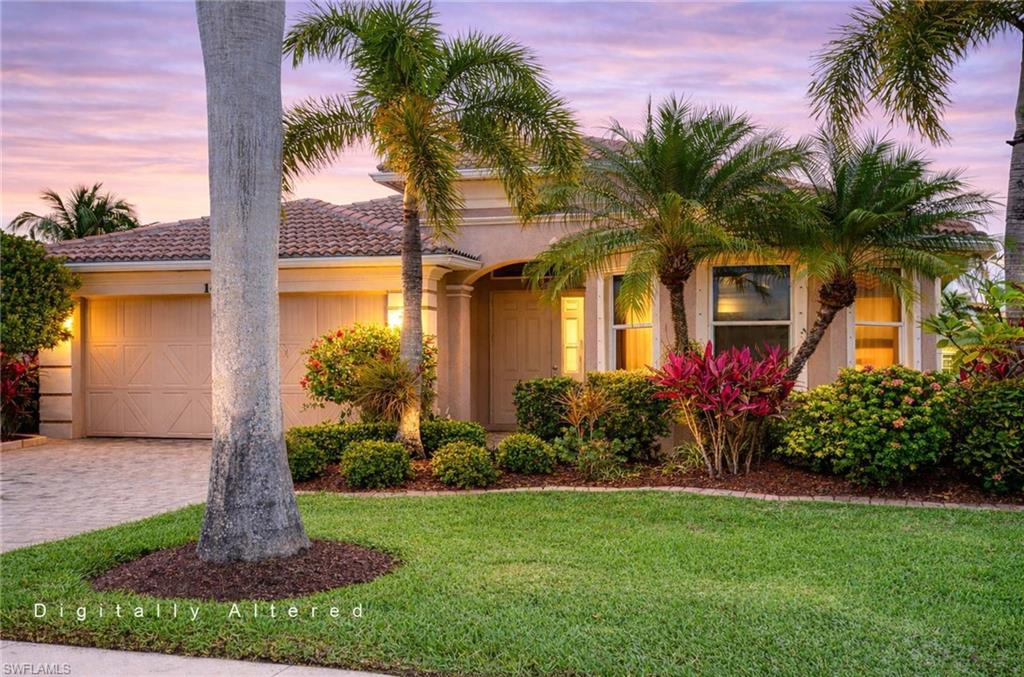 14809 Canton Court Naples, FL 34114 - Photo 1 of 43 a front view of yellow house with a garden and yard