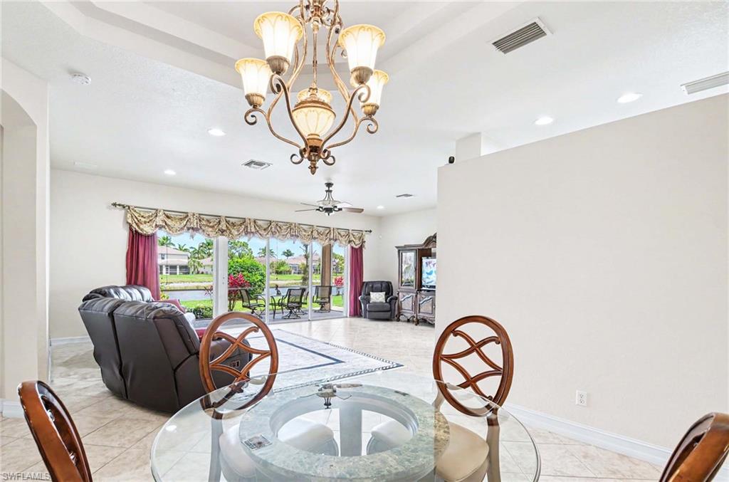 14809 Canton Court Naples, FL 34114 - Photo 13 of 43 a room with furniture a chandelier and a large window
