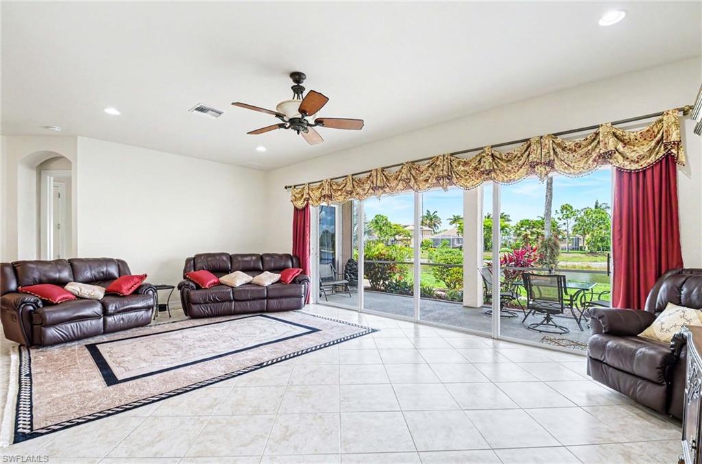 14809 Canton Court Naples, FL 34114 - Photo 7 of 43 a living room with furniture and a large window