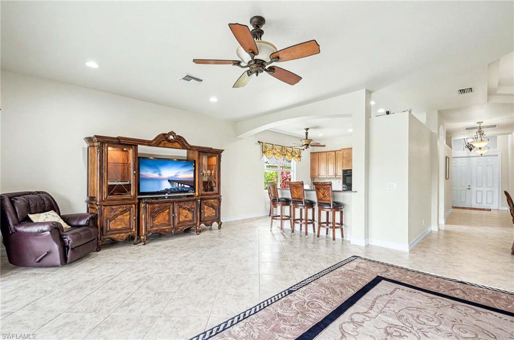 14809 Canton Court Naples, FL 34114 - Photo 8 of 43 a living room with furniture and a flat screen tv