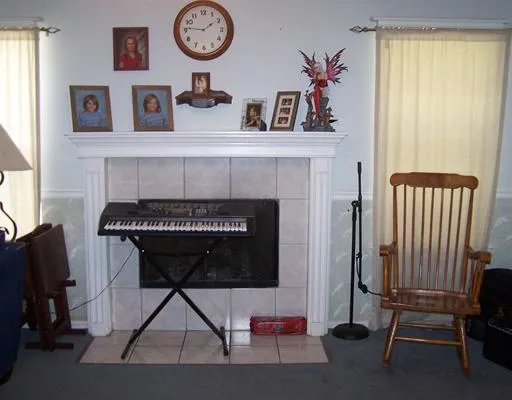 a picture of a room with furniture and a fireplace