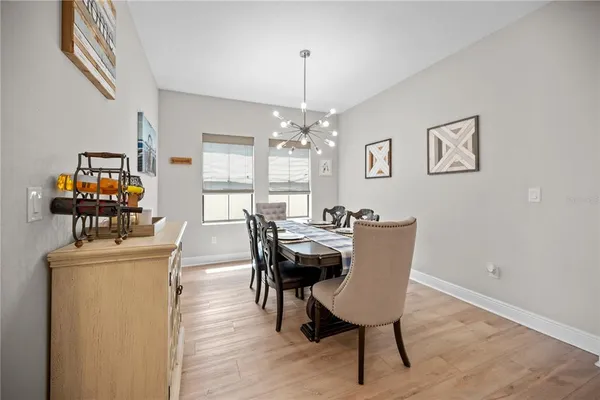a living room with furniture and a view of kitchen