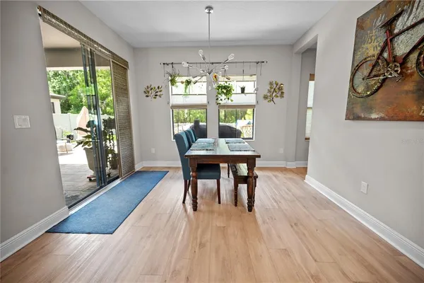 a view of a backyard with table and chairs with a barbeque grill and plants
