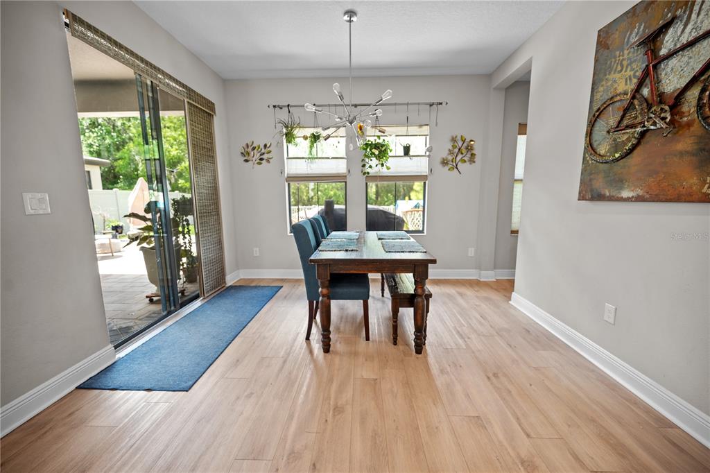 14734 Horse Trot Road Lithia, FL 33547 - Photo 26 of 66 a view of a dining room with furniture window and wooden floor