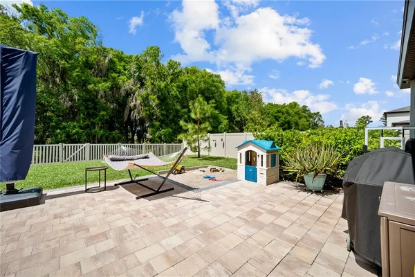 a view of a chairs and table in backyard