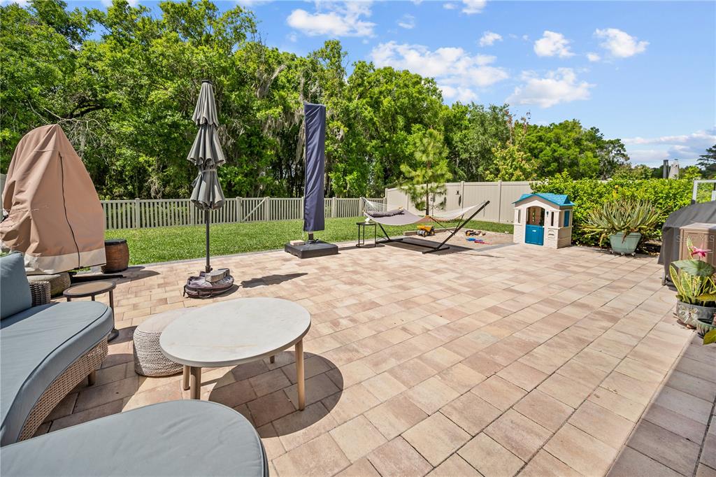 14734 Horse Trot Road Lithia, FL 33547 - Photo 32 of 66 a view of a chairs and table in backyard