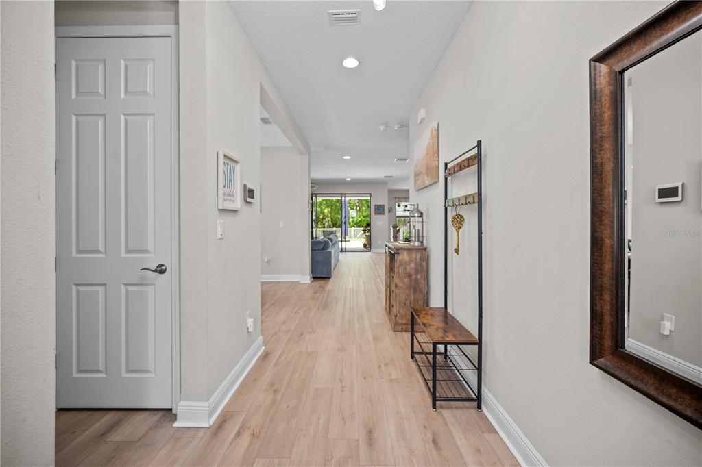 14734 Horse Trot Road Lithia, FL 33547 - Photo 4 of 66 a view of a hallway view with wooden floor and living room