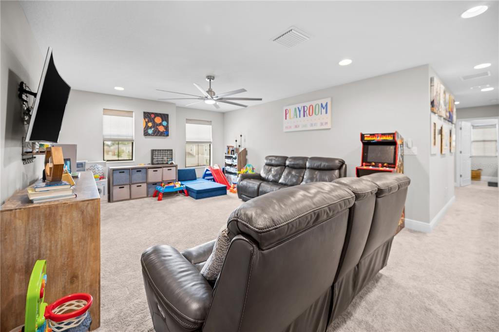 14734 Horse Trot Road Lithia, FL 33547 - Photo 41 of 66 a living room with furniture and a flat screen tv
