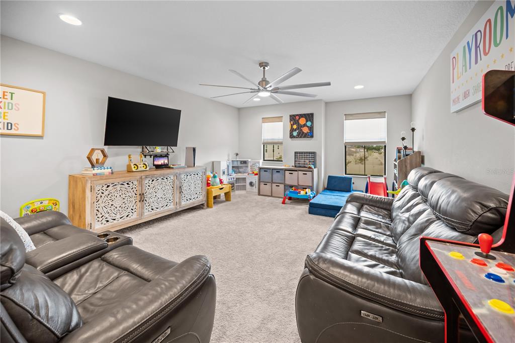 14734 Horse Trot Road Lithia, FL 33547 - Photo 42 of 66 a living room with furniture and a flat screen tv